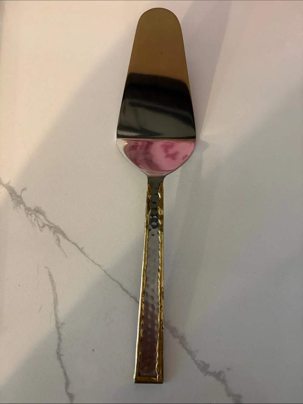 Silver cake server with hammered accents and gold trim